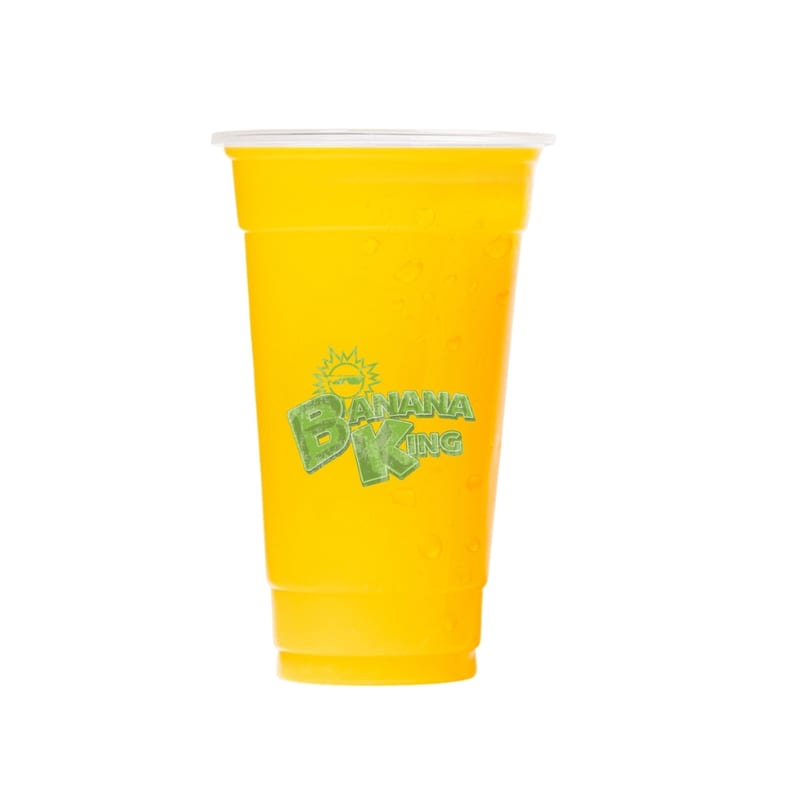 A Banana King branded cup filled with a vibrant yellow drink, covered in condensation droplets.