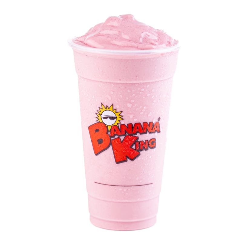 A Banana King strawberry milkshake in a clear plastic cup with the logo, against a white background.