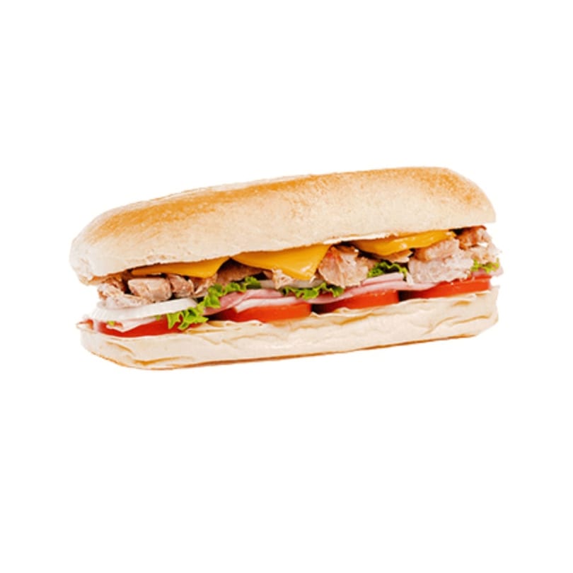 A Banana King submarine sandwich with meat, cheese, lettuce, onions, and tomatoes on a white background.