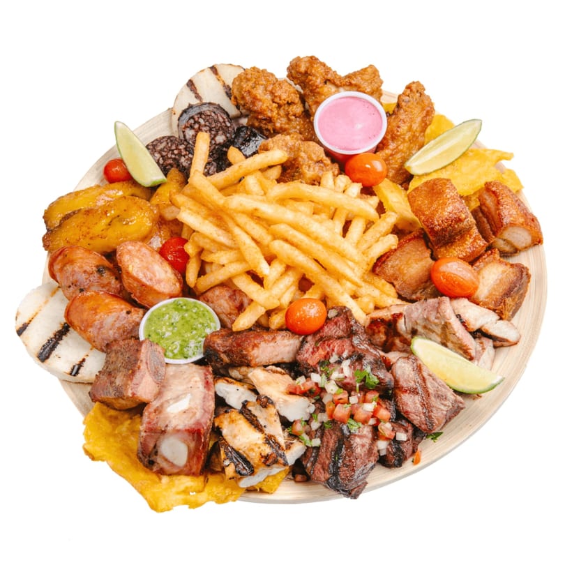 A large platter of fast-food items, including fries, fried chicken, sausages, and grilled meats.