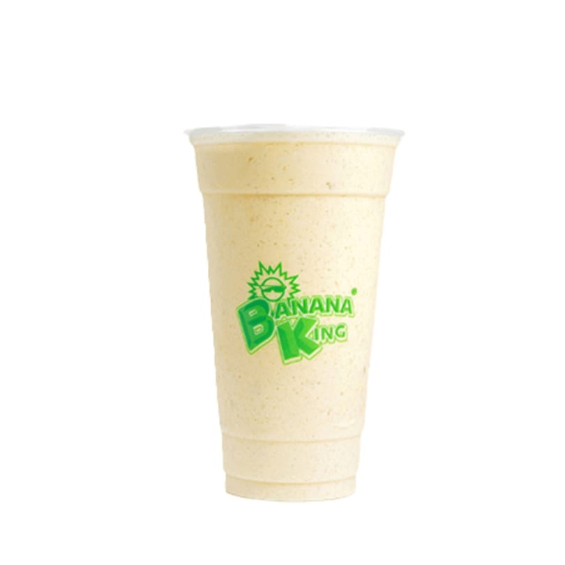 A Banana King banana smoothie in a clear plastic cup with the green logo on a white background.